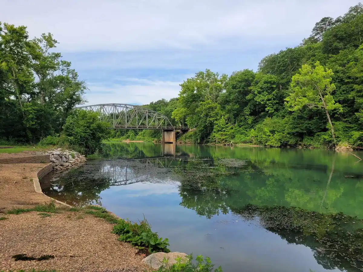 The Eleven Point River runs clear and green through Ozark forest.