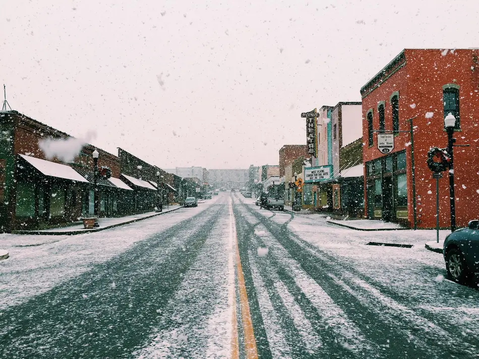 Snow falls on brick storefronts along Washington Avenue in downtown West Plains.